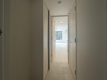 フラットなつくりの玄関。靴やさまざまなものが入れられる収納もひとつ。